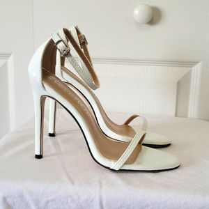 White ankle strap sandals. Thin toe strap. 4 inch heel.